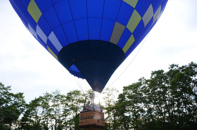 Phil Clinger launches a hot air balloon Sunday in Hickory Corners