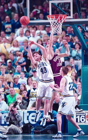 Henderson County's Brian Bivens (10) and Muhlenberg North's Wes Mayes (43) fight for the rebound during the 1999 Sweet 16 at Rupp Arena.