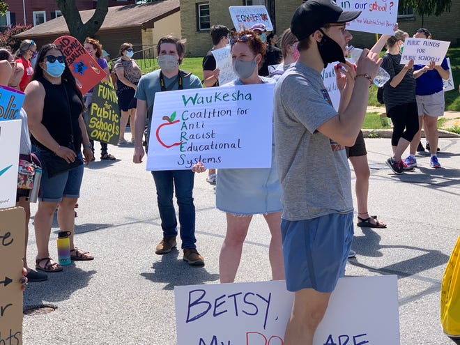 Protesters carrying Waukesha CARES signs mix with others awaiting the arrival of Vice President Mike Pence at the Waukesha STEM Academy Saratoga campus school on Walton Avenue on Tuesday, June 23. The group generally voiced concerns about equality in education, dovetailing with national concerns about charter schools and education funding.
