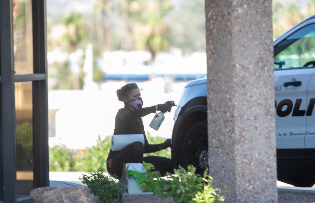 A Riverside County sheriff's deputy responding to a reported alarm at a gun shop in Palm Desert late Monday fatally shot an armed suspect who exited the business, a sheriff's department spokeswoman said. In this photo an individual cleans a vehicle belonging to Riverside Sheriff's Department.
