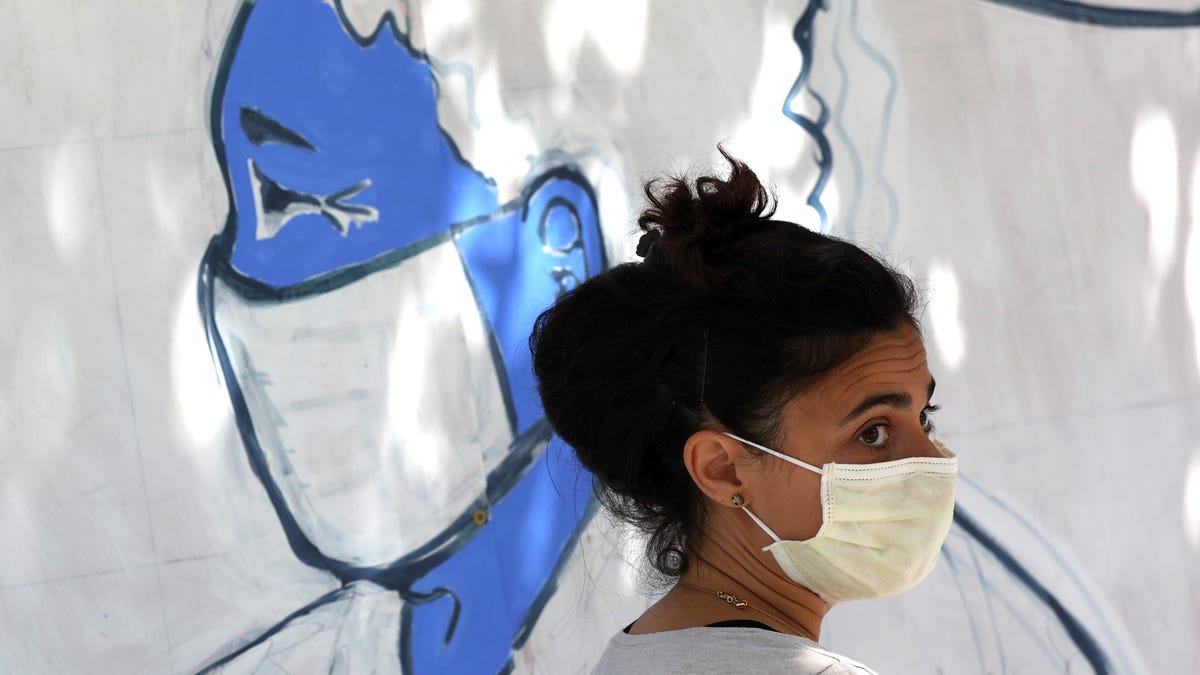 An Emergency room doctor paints a mural outside of Zuni restaurant to honor medical workers during coronavirus COVID-19 pandemic on June 22, 2020 in San Francisco, California. Doctors and medical workers helped paint a mural honoring healthcare workers on boarded up windows in a project spearheaded by San Francisco General Hospital Foundation and Paint the Void. 