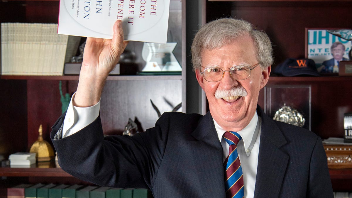 John Bolton mimics photos of President Trump holding a bible after an interview with USA TODAY's Washington, DC bureau chief Susan Page in advance of the release of his book, 'In the Room Where It Happened.'