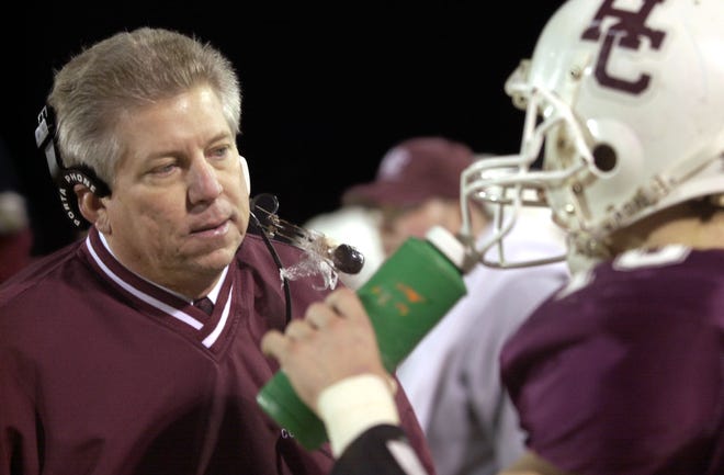 Henderson County coach Tom Duffy talks with quarterback Wes Peckenpaugh on the sidelines during the 2002 regional championship game at Colonel Stadium.