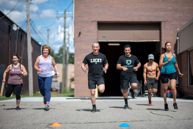 People participate in an outdoors cross-fit class at High Caliber Strength and Fitness, in Troy, June 25, 2020.