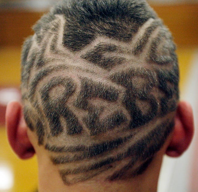 A Racine Horlick High School student shows off a haircut with the word "Rebels" shaved into the back of his head in this 2009 file photo. Controversy over the school's Confederate imagery and mascot have been longstanding community issues.