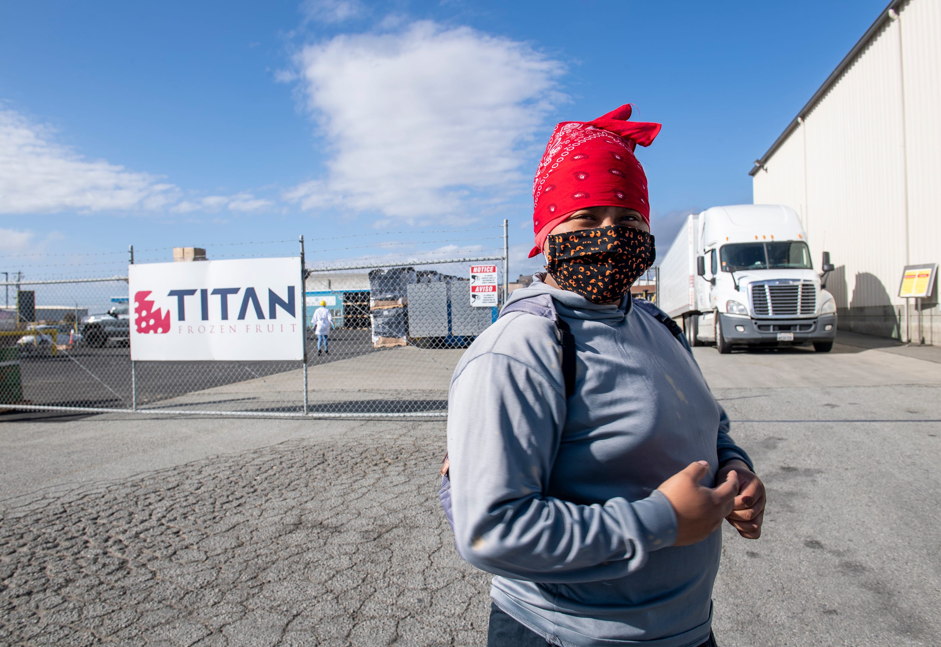 Resi Salvador, 19, waits in line to enter her new job at the Titan frozen fruit company. It is a summer job that she got to help her parents with the rent of their two-bedroom apartment in north Salinas, Calif. 