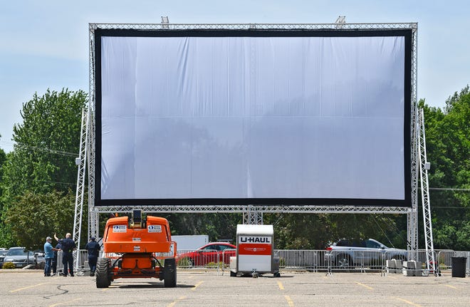 A large screen is set up in the parking lot outside Crossroads Center on the north side Thursday, June 25, 2020, in St. Cloud. The pop-up outdoor drive-in cinema will begin shows Friday. 