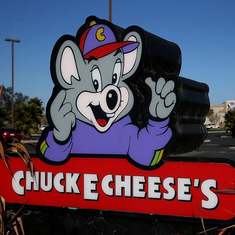 A sign is posted in front of a Chuck E. Cheese res
