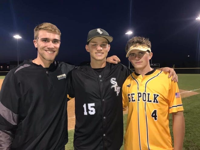 Southeast Polk senior baseball player Evan Martin, center, is flanked by brothers Austin, left, and Owen, right. Owen Martin was struck by a car while riding a bicycle in 2018 and suffered a traumatic brain injury.
