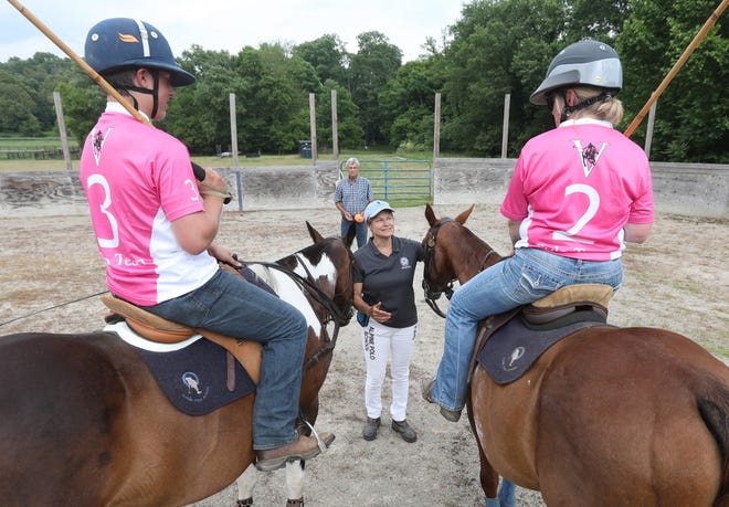Sheila Everett gets ready to start a polo match Dylan Starner, left and his aunt Debbie Earnest. Holding the polo balls behind her is her husband Troy. The Everetts run Alpine Polo School in Frazeysburg.