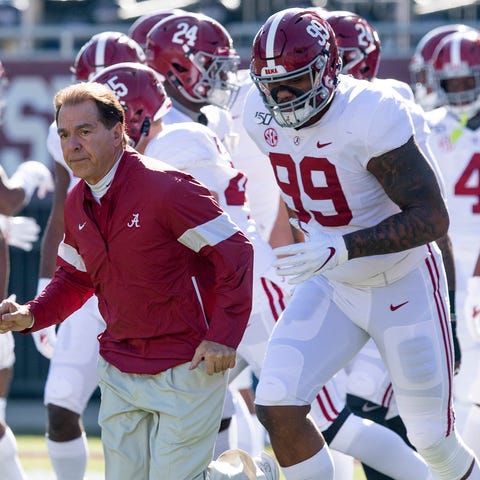 Nick Saban leads the team out for warm ups before 