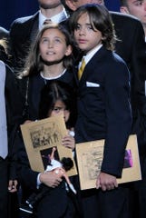 Paris Jackson with her older brother Prince Jackson, and her younger brother, Prince Michael Jackson II, at their father's public memorial service at the Staples Center on July 7, 2009, in Los Angeles.
