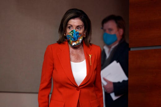House Speaker Nancy Pelosi of Calif., wears a face mask as she arrives to speak at a news conference on Capitol Hill in Washington, Friday, June 26, 2020.