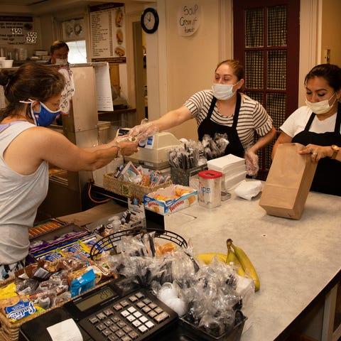 Laura Hernandez and Agueda Hernandez serve a custo