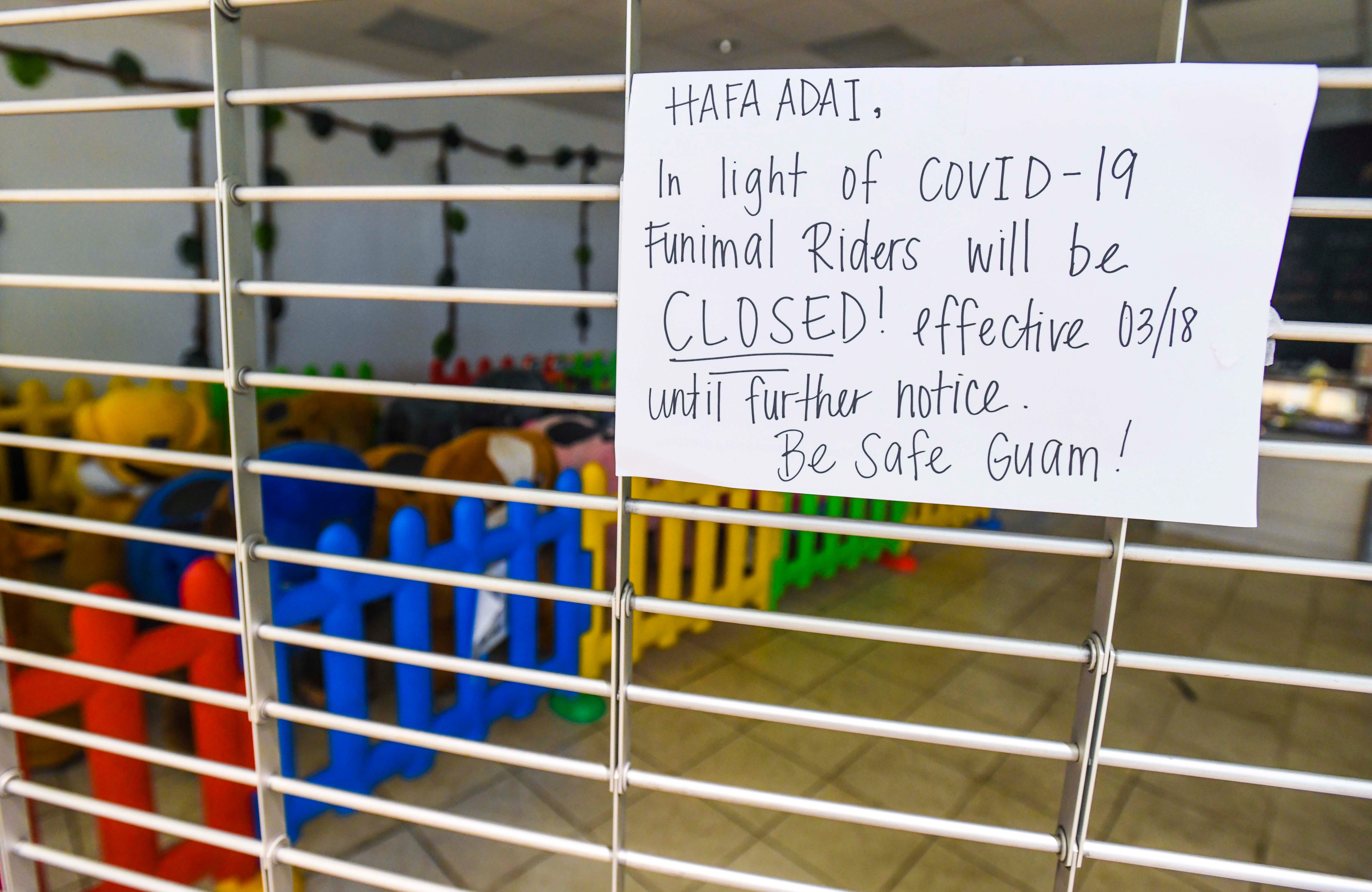 A sign posted on a security gate of the Funimal Riders store in the Agana Shopping Center in this June 27, 2020, file photo, informs shoppers of the company's decision to temporarily close the business due to the coronavirus pandemic.