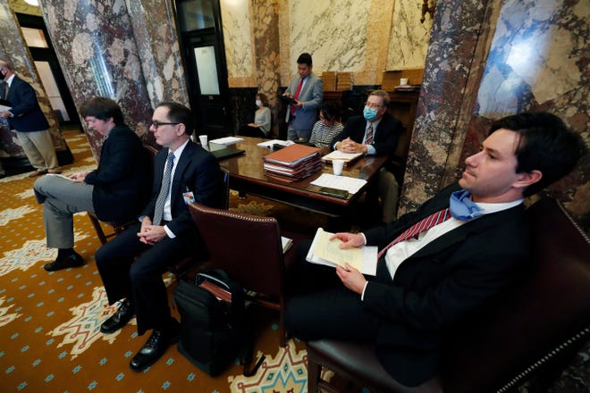 Members of the Legislative Budget Office monitor the presentation of some appropriation and finance bills for debate on the Senate floor at the Capitol in Jackson, Miss., Friday, June 12, 2020. Due to concerns over the coronavirus, lawmakers suspended the Legislative session for several weeks and are now catching up with proposed legislation. (AP Photo/Rogelio V. Solis)