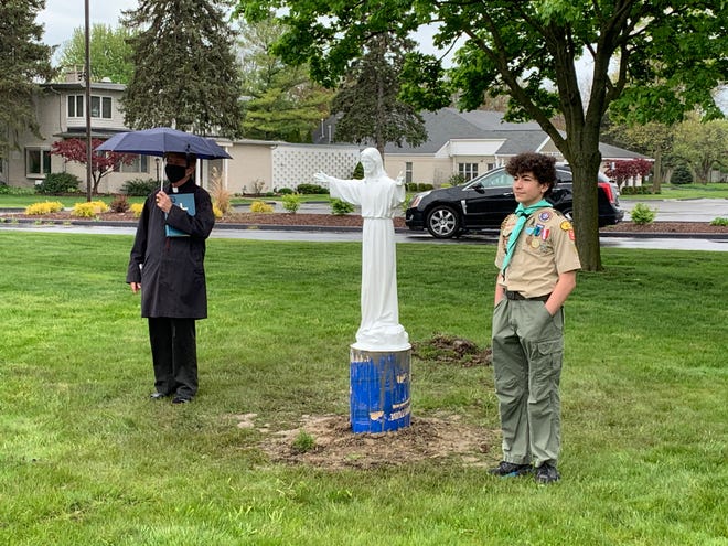 Fr. Jim McNulty, pastor of St Edith Church in Livonia, stands with Andrew Atala, Eagle Scout candidate.