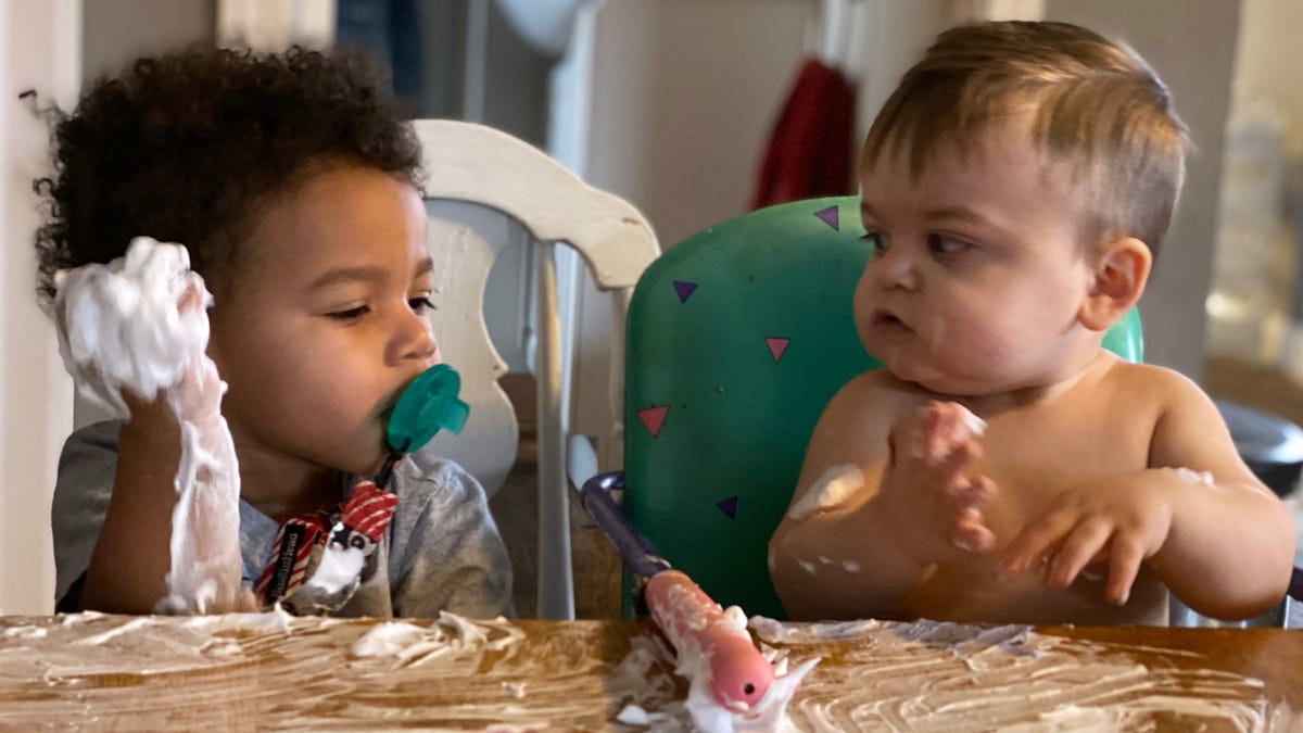 Kendrick Brisco, 1, looks at Josiah Gingerich, also 1, as they smear shaving cream on the kitchen table at the home of child care provider Wendy Tilma in Byron Center, Michigan.