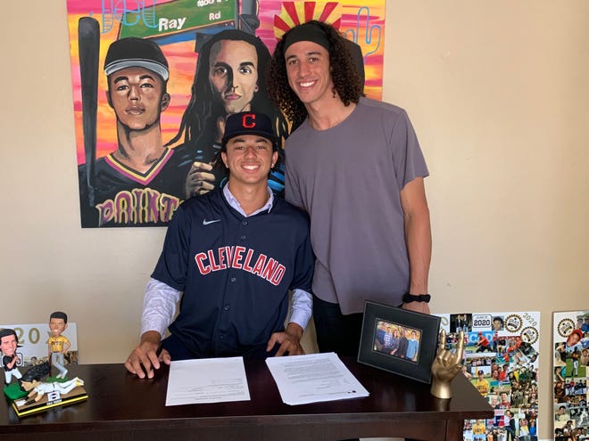 Mountain Pointe's Carson Tucker (left, with brother Cole of the Pittsburgh Pirates), signs his first professional contract with the Cleveland Indians.