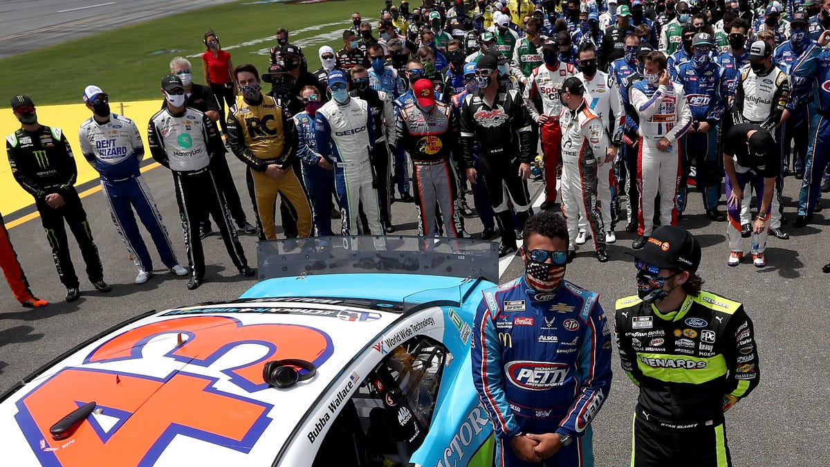 NASCAR drivers stand in solidarity with Bubba Wallace, driver of the #43 Victory Junction Chevrolet, during pre-race ceremonies prior to the NASCAR Cup Series GEICO 500 at Talladega Superspeedway on June 22, 2020.