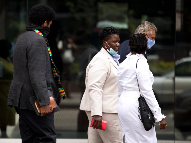 Tamaya Dennard, center, former Cincinnati City Council member, speaks to Iris Roley, Cincinnati activist, as she leaves the federal courthouse in Cincinnati on Monday, June 29, 2020. Tamaya Dennard pleaded guilt to a federal fraud charge. 