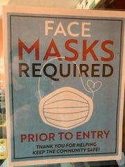 Mexican Fiesta restaurant in Dearborn Heights has a face mask sign posted on its door.