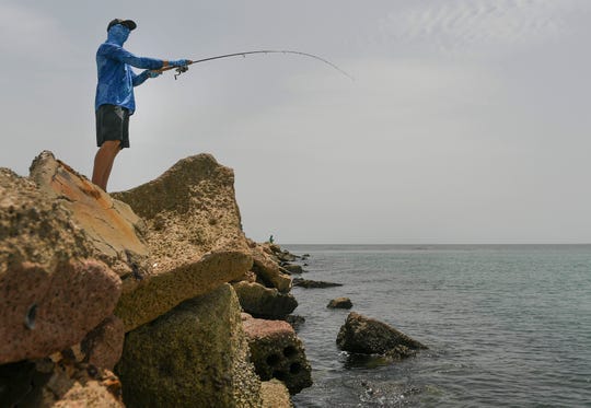 Sonny East, of Miami, tries his luck at catching a snook while fishing with his father, David East (not pictured), of Vero Beach, on Monday, June 29, 2020, at the Fort Pierce Jetty, on the south side of the Fort Pierce Inlet. "I caught 10 the other day," Sonny East said, referring to Thursday. "I think it's really fun. They're great gamefish, they bite when they want to bite, which isn't all the time, that's for sure."