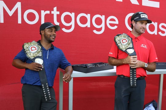 Harold Varner III, left, and Bubba Watson pose with their champions belt after being the winners of the Rocket Mortgage Classic's 'Changing the Course' charity golf event at Detroit Golf Club, July 1, 2020.