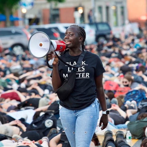 An organizer with a bull horn speaks to thousands 