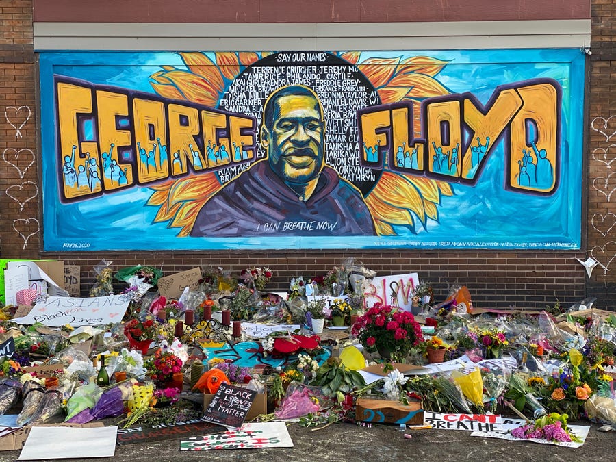 Cards and flowers accumulate at a makeshift memorial for George Floyd near the spot where he died while in police custody in Minneapolis.
