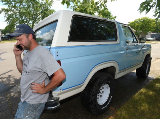 John Parks talks on the phone while standing near the rear of this 1985 Full-Size Bronco (FSB), owned by his fiancee, Shanna Gibson (not pictured).