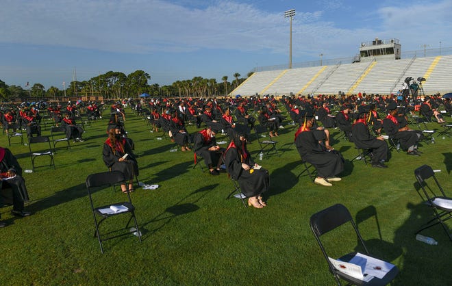Graduating seniors from Port St. Lucie High School participate in the school's in-person commencement ceremony on Thursday, July 2, 2020, at Lawnwood Stadium in Fort Pierce. More than 390 seniors were candidates for graduation in the class of 2020, but the COVID-19 virus cut short the end of the school year, and delayed the formal in-person graduation ceremonies until this week. The participating graduates walked across the stage, but did not collect diplomas, or handshakes, with the school staff as a precaution to help prevent the spread of the virus.