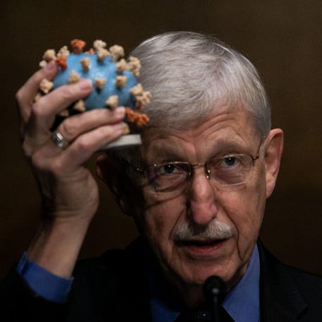 Director of the National Institutes of Health, Dr. Francis Collins, holds a model of the coronavirus as he testifies in 2020 at a Senate hearing to review Operation Warp Speed, the White House initiative to develop and distribute the COVID-19 vaccine.