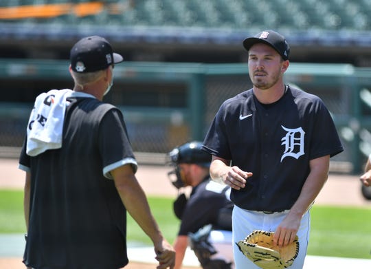 From left, Tigers pitching coach Rick Anderson talks with Beau Burrows.  Detroit Tigers work out at Comerica Park in Detroit on July 6, 2020.