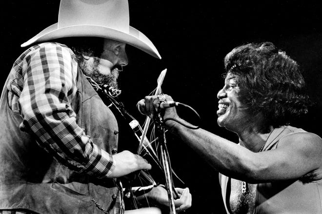 Host Charlie Daniels, left, match the intensely energetic performance of James Brown during the ninth annual Volunteer Jam nine-hour marathon concert at the Municipal Auditorium Jan. 22, 1983.