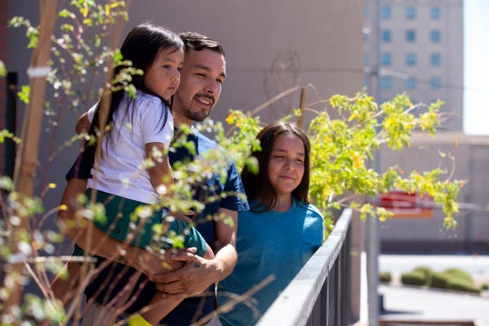 Reynaldo Galindo, 31, stands with his sons, Royall, 4, and Myson, 11, on July 6, 2020, at Urban Living on Fillmore in downtown Phoenix. Galindo and his children were living with friends before finding a three bedroom apartment at the new affordable housing project.