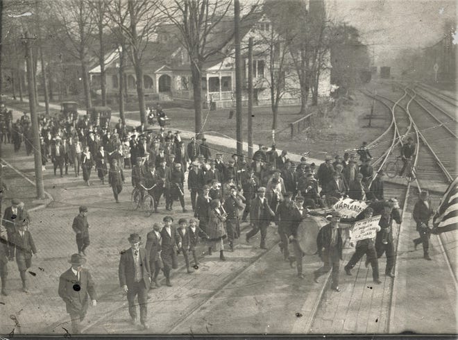 Marchers cross the tracks on Croghan Street in a 1918 parade.