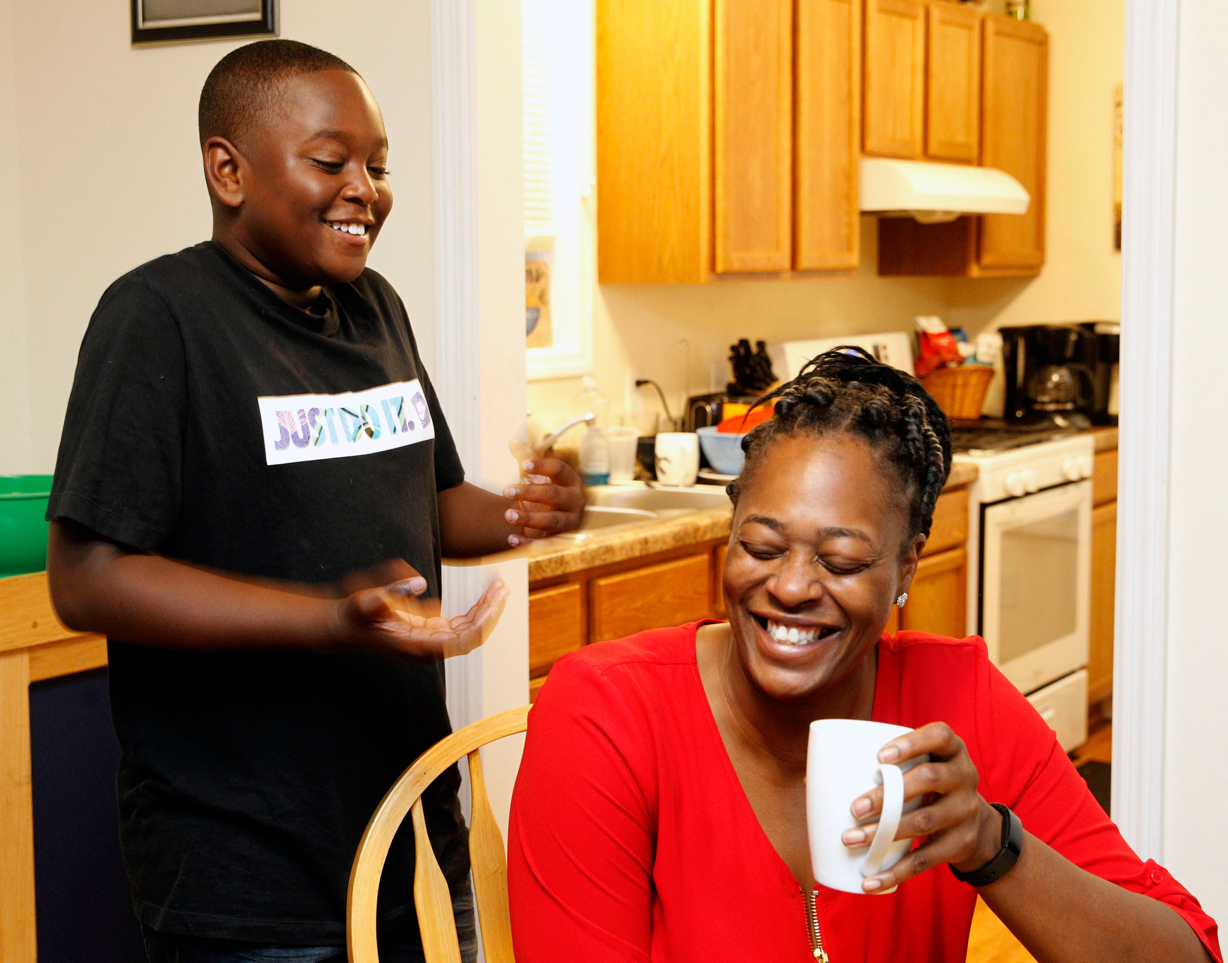 Matthias Jeffrie enjoys a moment with his mother LaVera Jeffrie at their St. Paul home on Sept. 30.  Jeffrie and her son have been in their Habitat for Humanity home since 2017. She and Matthias collaborated on how to decorate it.