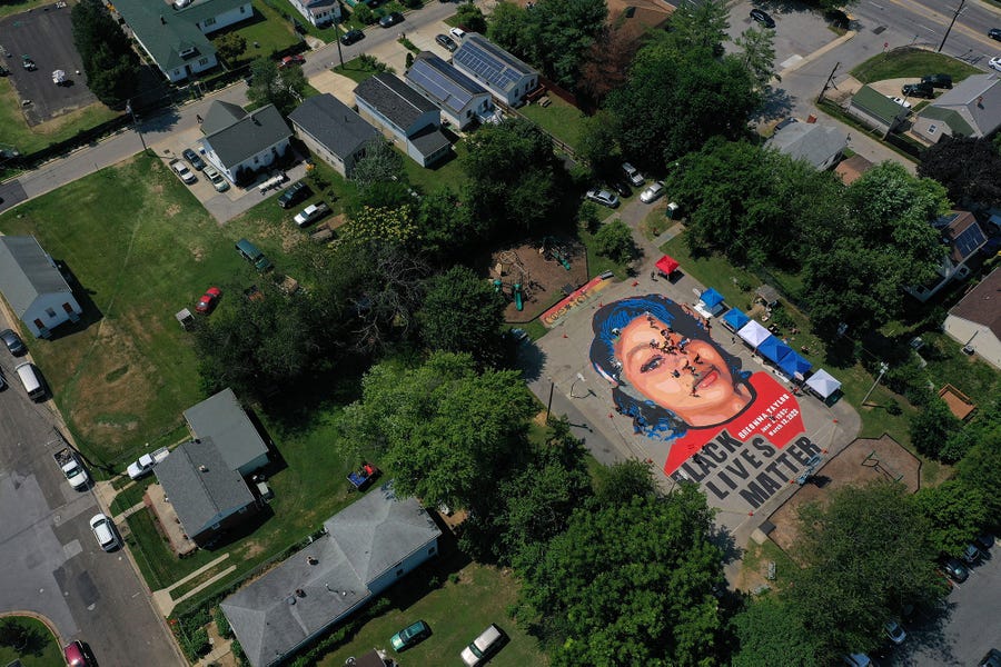 A large-scale ground mural depicting Breonna Taylor with the text 'Black Lives Matter' is seen being painted at Chambers Park on July 5, 2020 in Annapolis, Maryland. The mural was organized by Future History Now in partnership with Banneker-Douglass Museum and The Maryland Commission on African American History and Culture. The painting honors Breonna Taylor, who was shot and killed by members of the Louisville Metro Police Department in March 2020. 