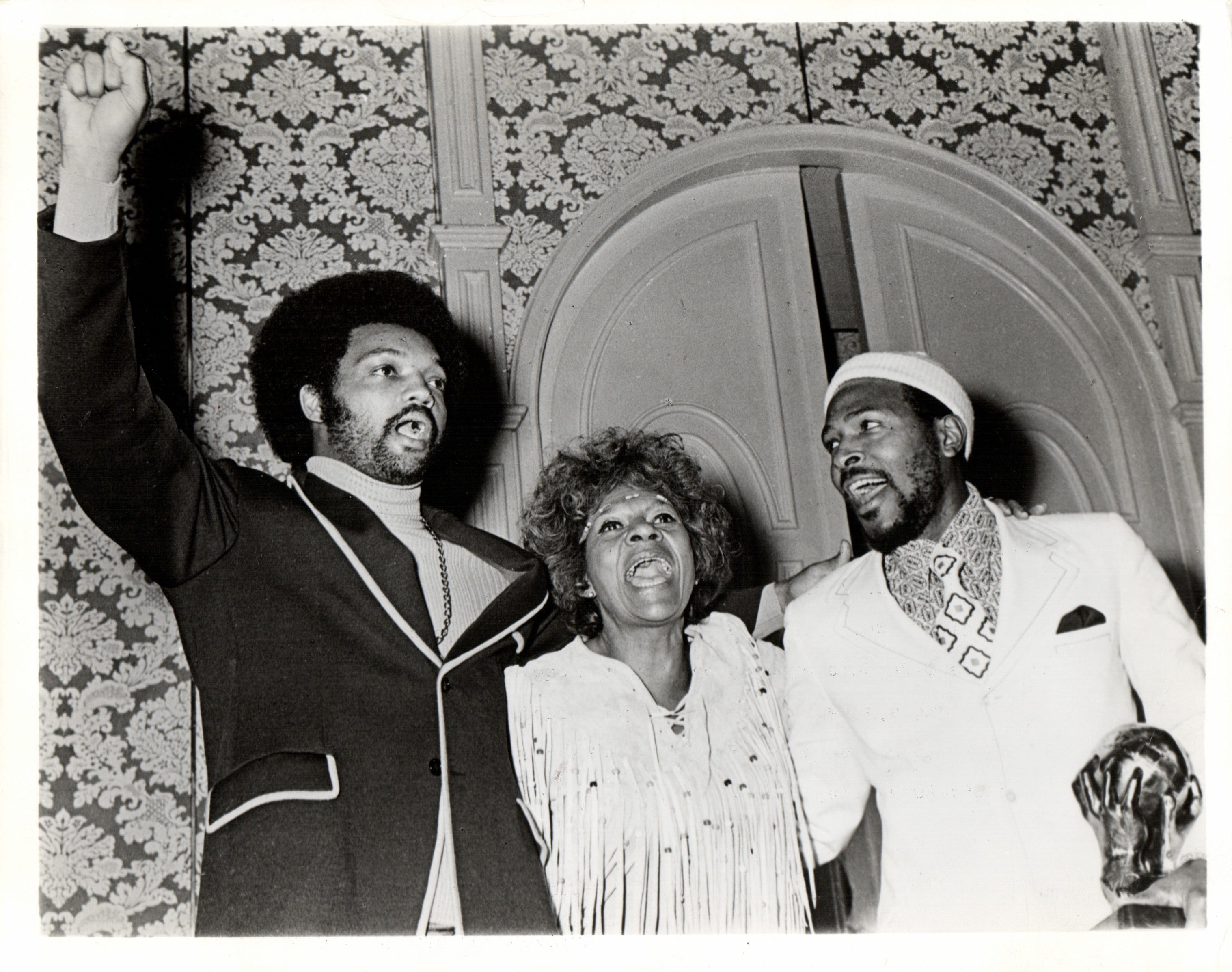 Marvin Gaye, clutching one of three Image Awards received at the NAACP's 5th Annual Image Awards Show in Hollywood, sings "Lift Every Voice and Sing" with awards chairman Maggie Hathaway and the Rev. Jesse L. Jackson on Nov. 21, 1971
