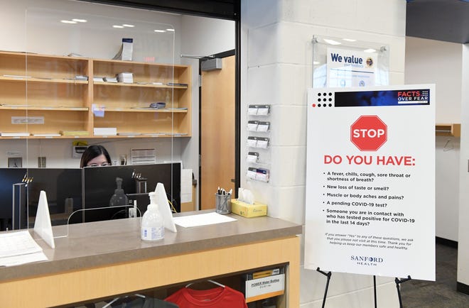 A coronavirus symptom checkpoint station is set up at the front desk on Wednesday, July 8, at the Sanford Fieldhouse in Sioux Falls.