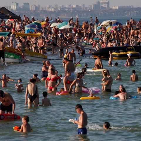 People enjoy the beach in the Black Sea in Odessa,