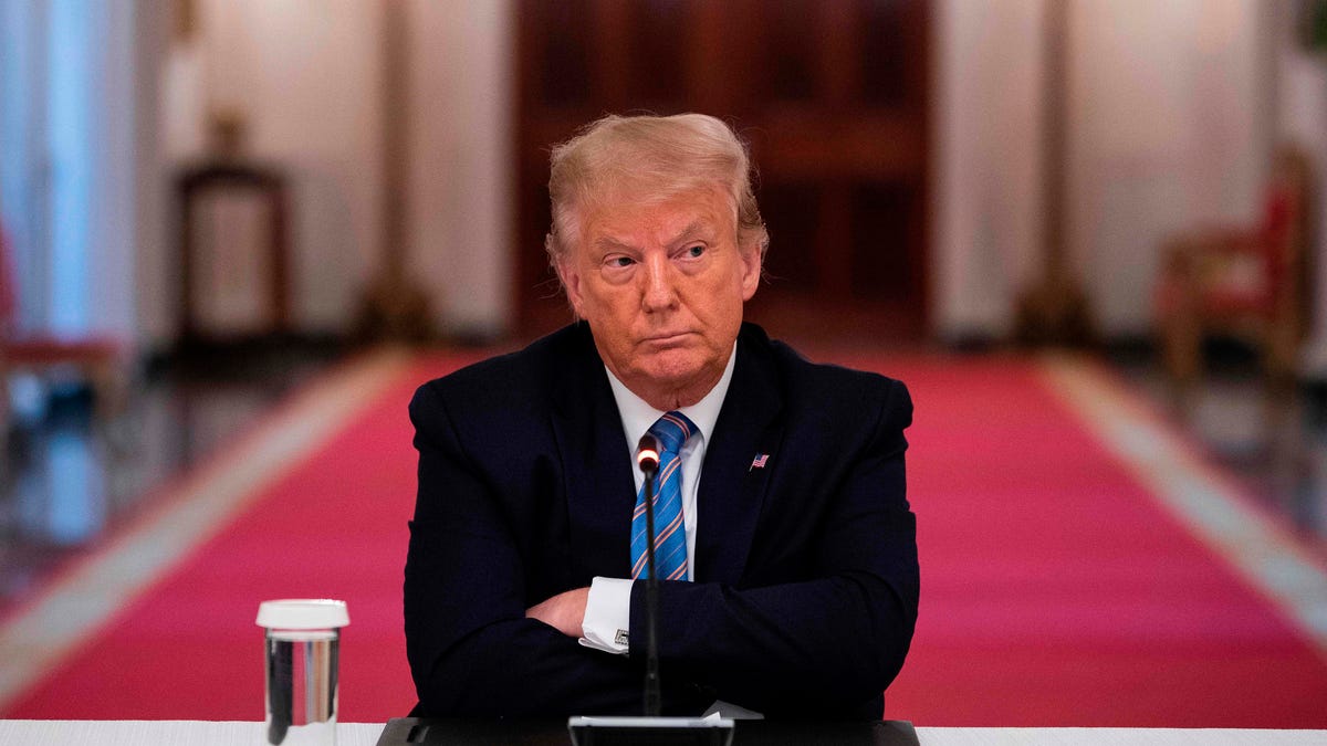 TOPSHOT - US President Donald Trump sits with his arms crossed during a roundtable discussion on the Safe Reopening of Americas Schools during the coronavirus pandemic, in the East Room of the White House on July 7, 2020, in Washington, DC. (Photo by JIM WATSON / AFP) (Photo by JIM WATSON/AFP via Getty Images) ORIG FILE ID: AFP_1US6DA