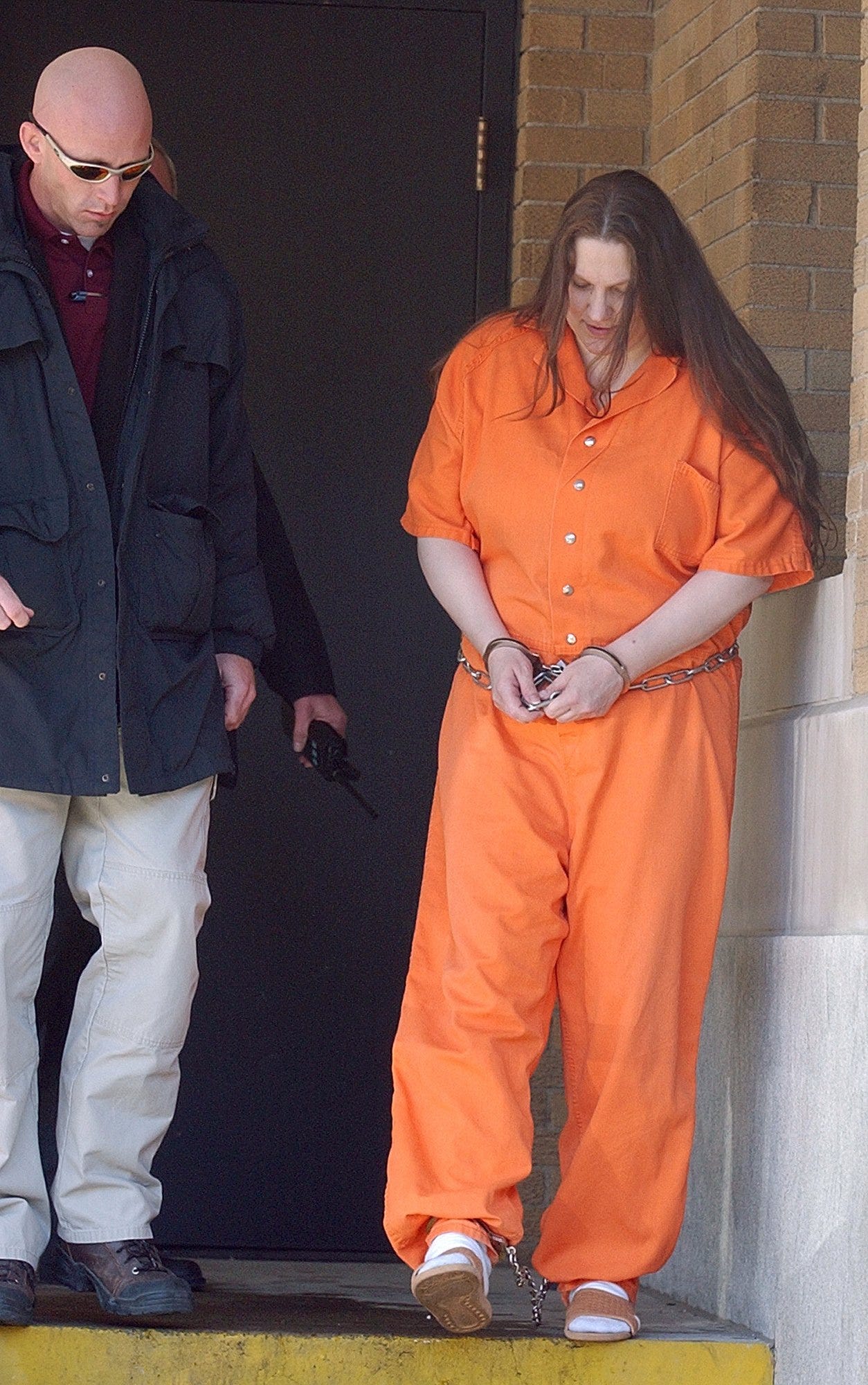 Angela Johnson is led from the U.S. Federal Building in Sioux City, Iowa, after a hearing Feb. 11, 2005.