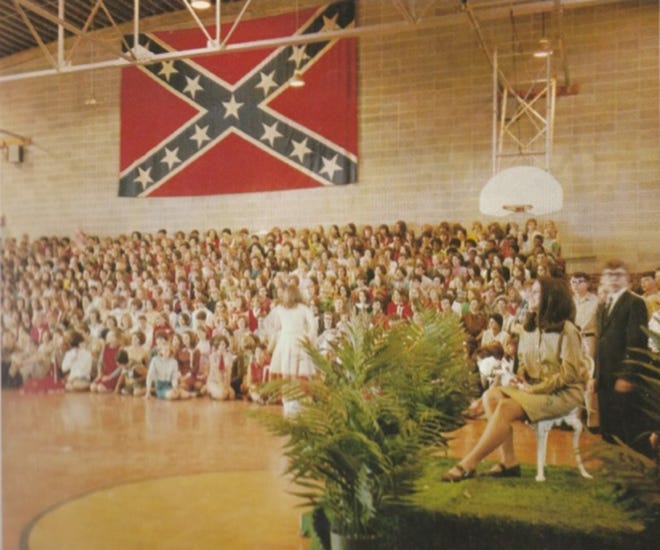 A Confederate flag hangs in the Robert E. Lee High School gym during a school assembly in 1968.