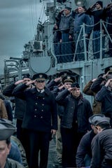 Capt. Krause (Tom Hanks) and Charlie Cole (Stephen Graham) salute during an onboard funeral in "Greyhound."