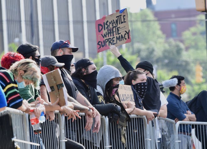 People protest the Confederate monument at the State House grounds in Columbia Friday, July 10, 2020.