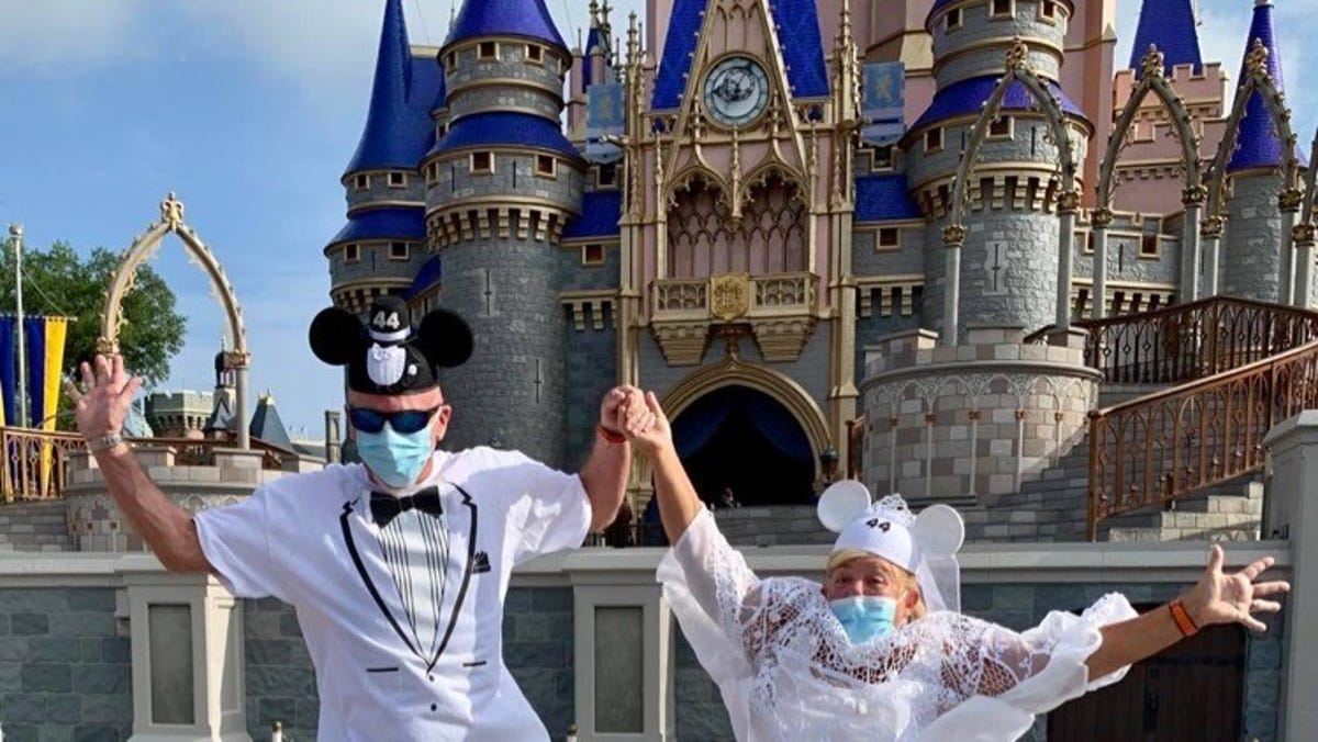 Steve and Carol Show of Port St. Lucie celebrate their 44th wedding anniversary at Walt Disney World's Magic Kingdom, which reopened to the public Saturday.
