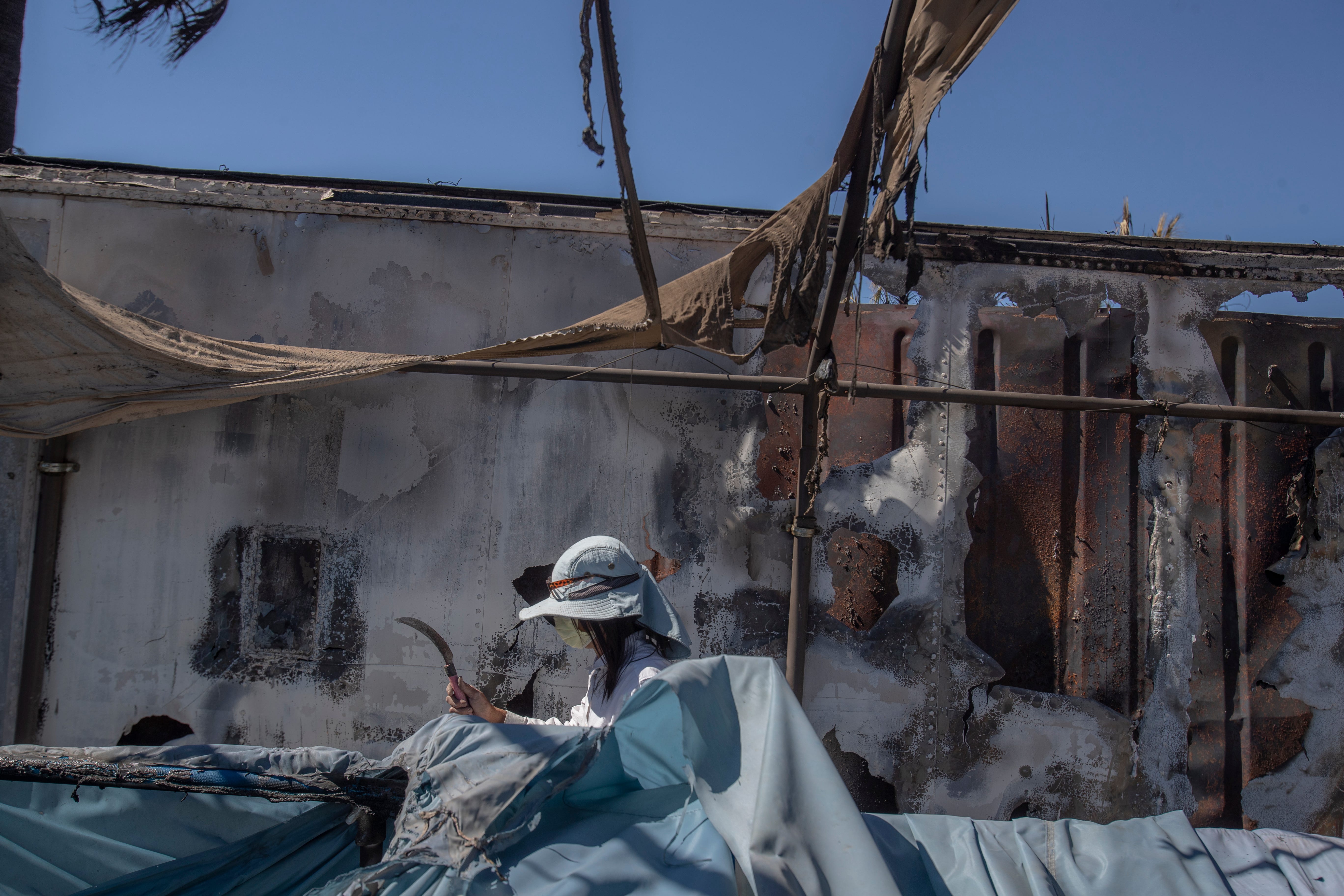 Satya Luffy begins to tear down material as the cleaning process begins on her 6-acre Niland property, a birding oasis that was destroyed in a June 28 fire. Luffy said she hoped to watch “everything come back. All the birds, all the green. I want to take care of all the animals.”