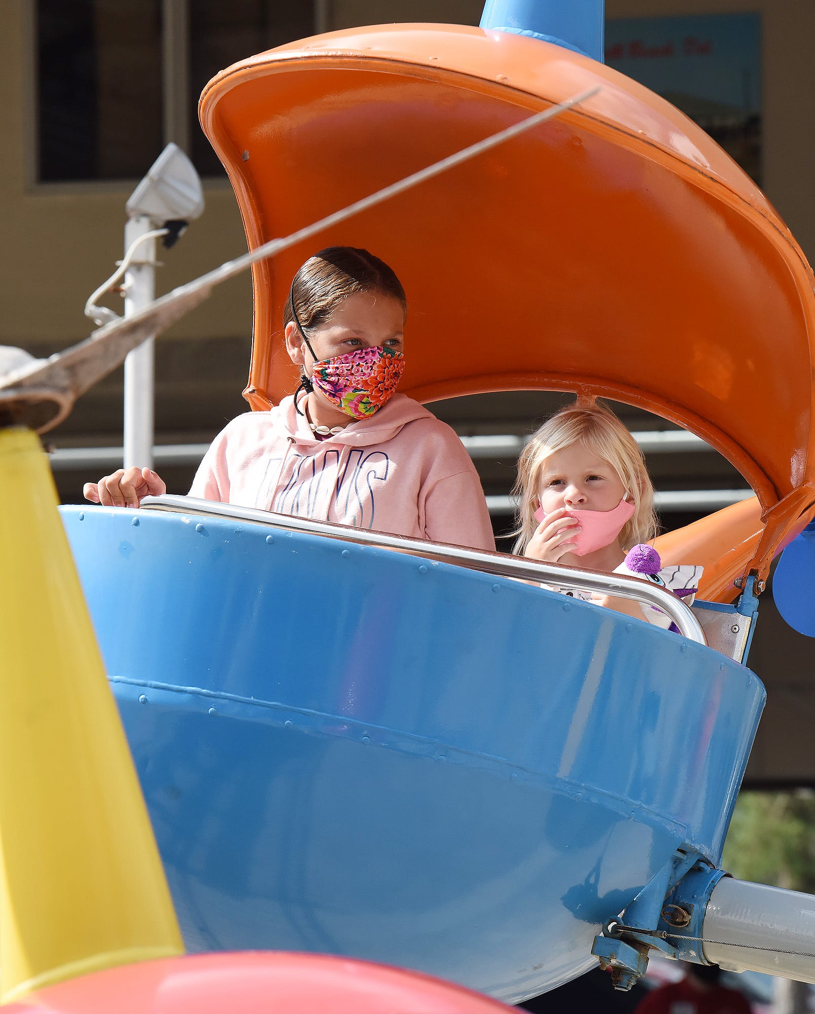 A mother and daughter riding a flat ride at Funland.